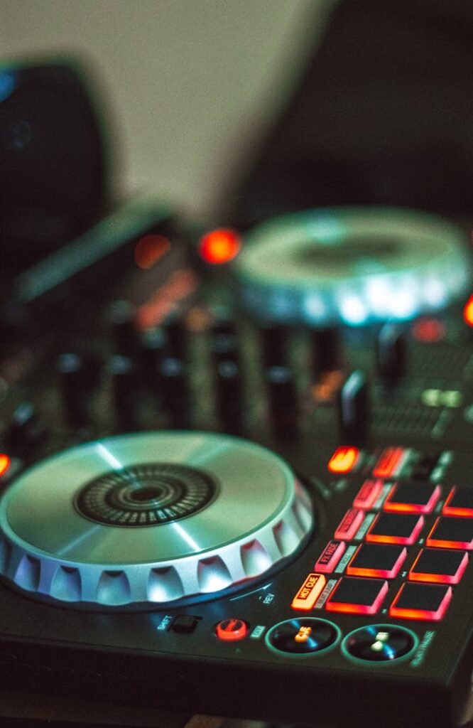 pexels photo 1481313 Close-up photo of a DJ controller with illuminated buttons, mixing dials, and controls.