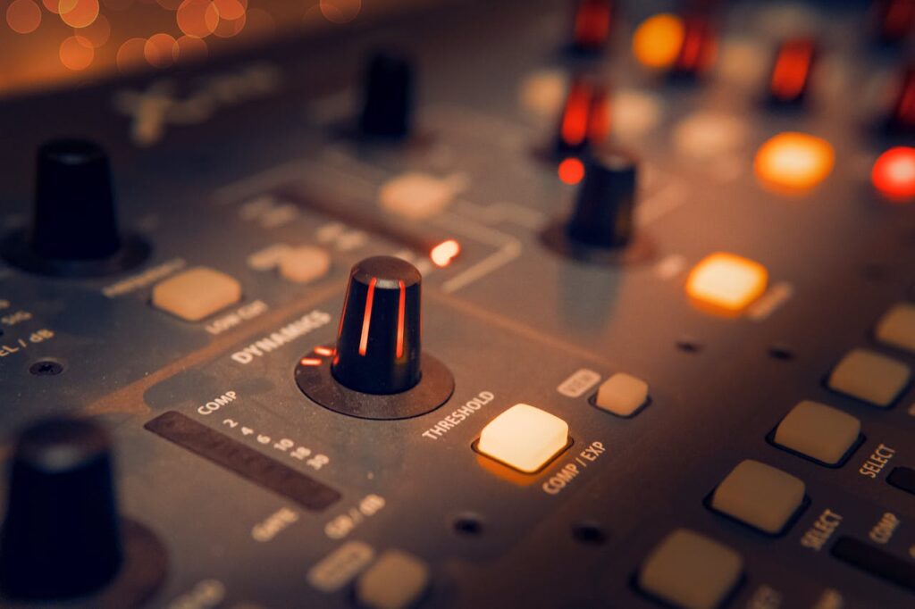 pexels photo 3784221 A detailed view of an audio mixer with glowing knobs, perfect for music production themes.